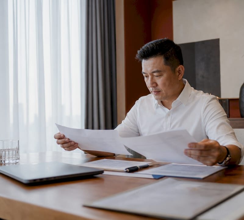 Homeowner reviewing ABSD tax documents at desk
