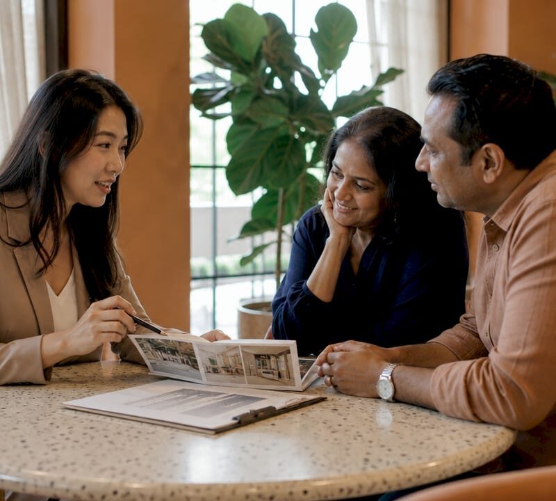 Buyer's agent discussing property options with clients