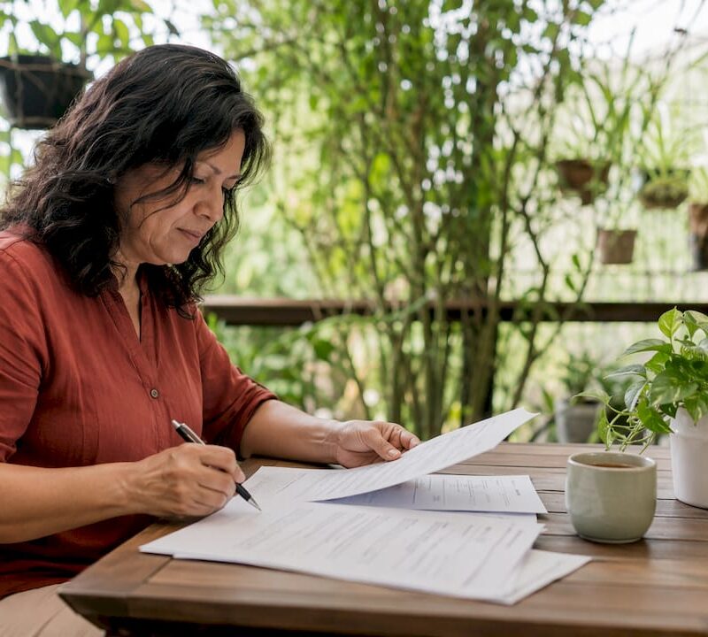 Woman reviewing tenancy agreement at kitchen table