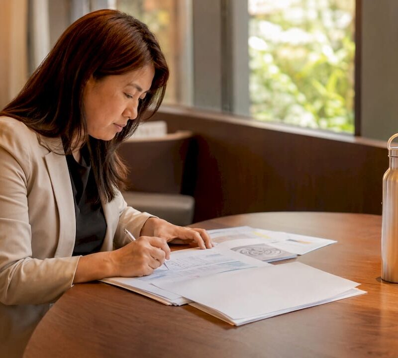 Real estate analyst reviewing cooling measures documents