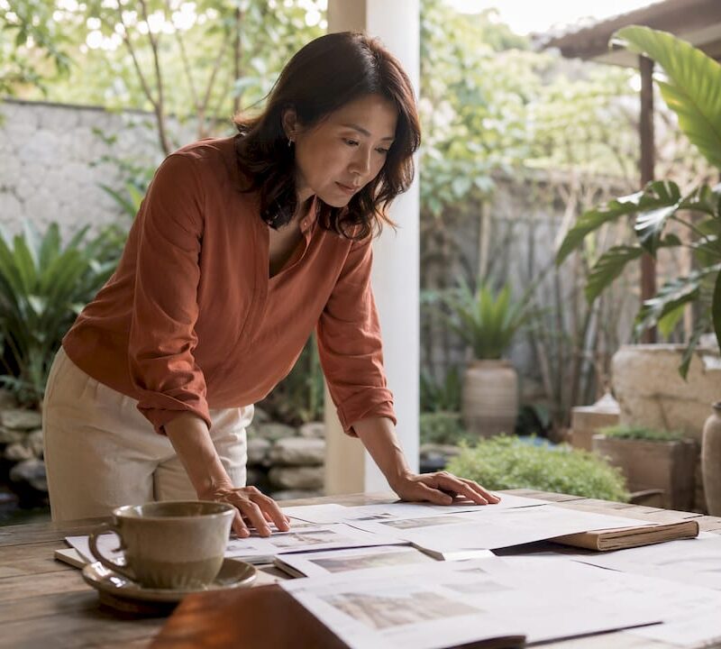 Investor reviewing real estate documents in home office