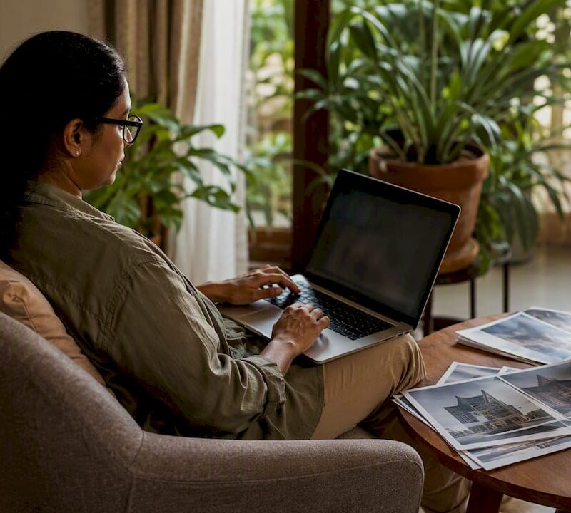 Woman browsing U.S. property listings at home laptop