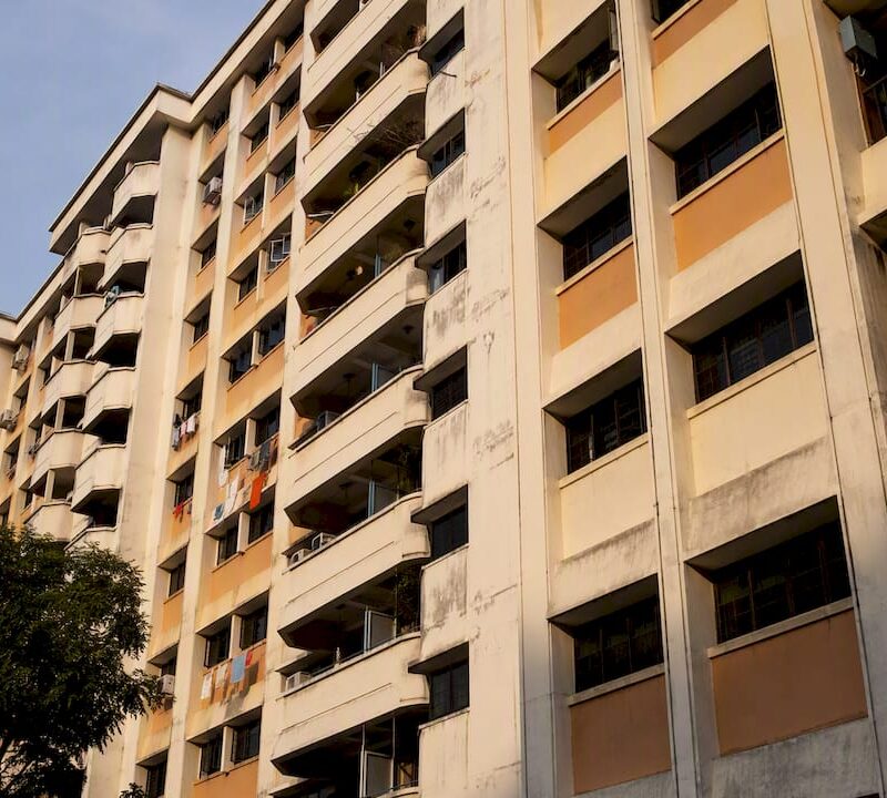 Exterior of a Singapore HDB flat showing aging facade