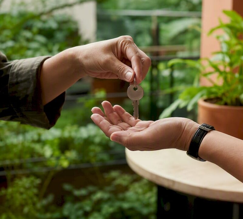 Hands exchanging apartment keys in Singapore