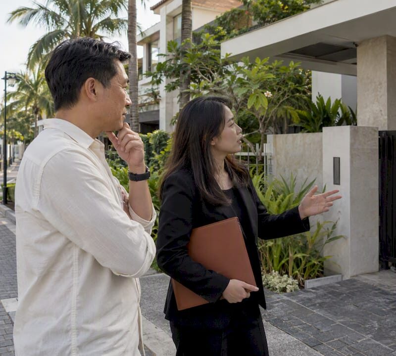 Buyer and lawyer reviewing landed property approval
